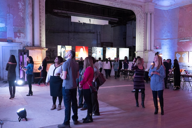 People attend an exhibition in the Carr Center's theater space